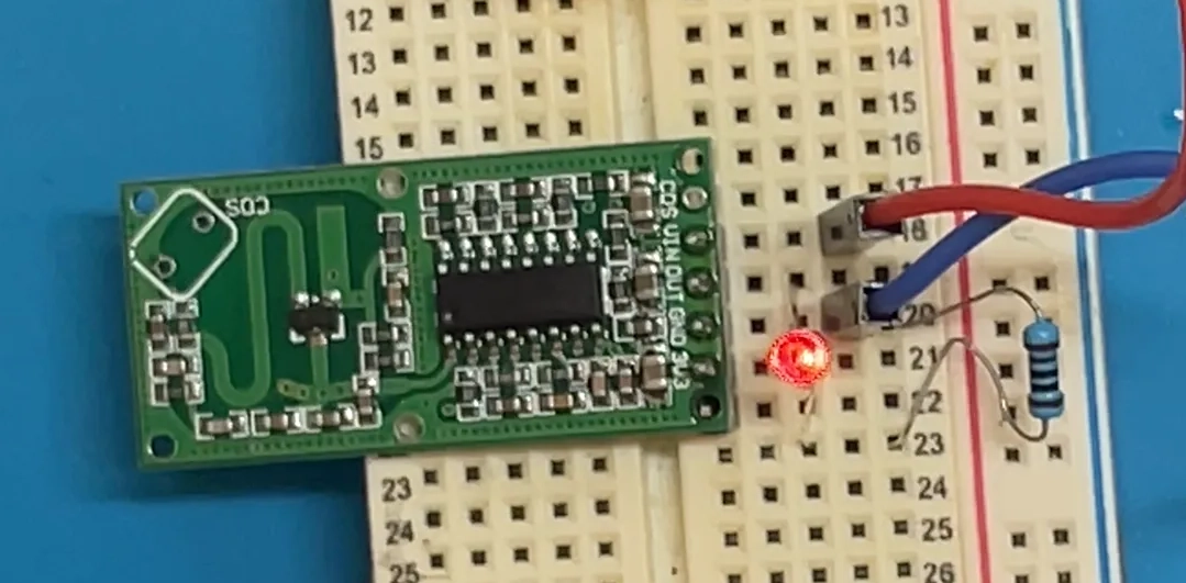 Radar module on a breadboard driving a red LED