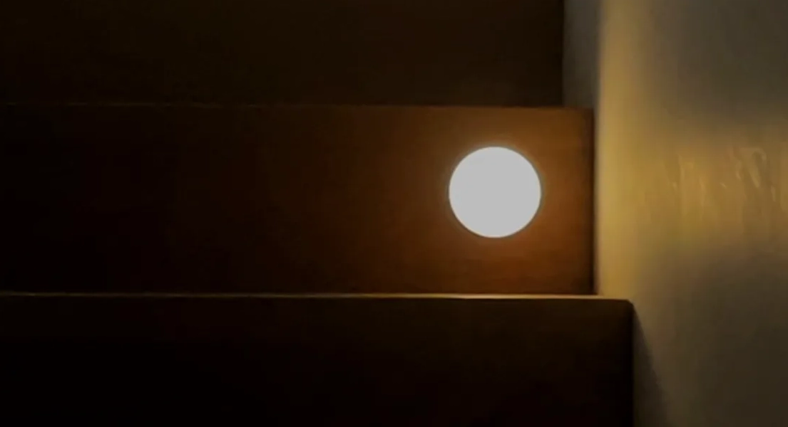The modified night light installed on the stairs, glowing