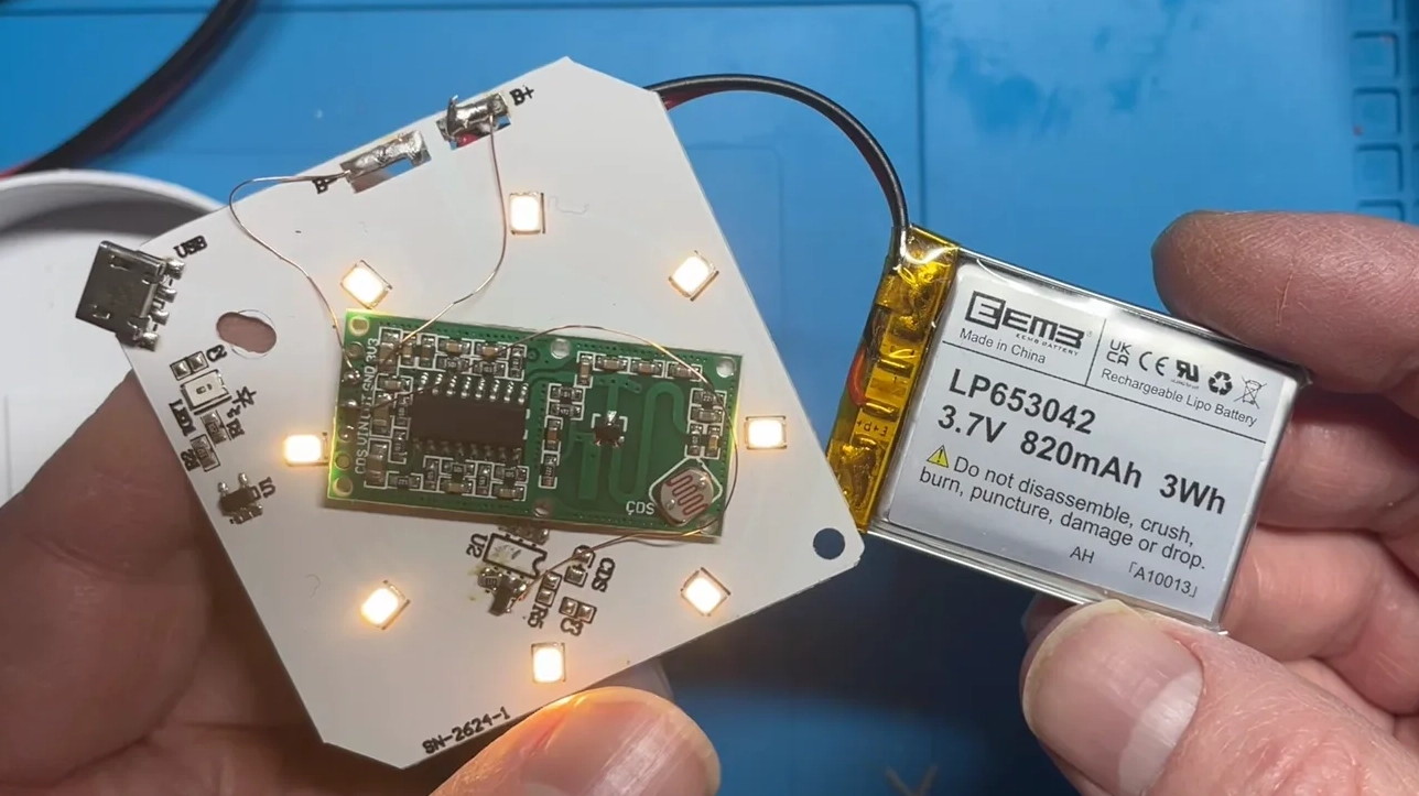 The modified board with the 820 mAh battery, LEDs lit